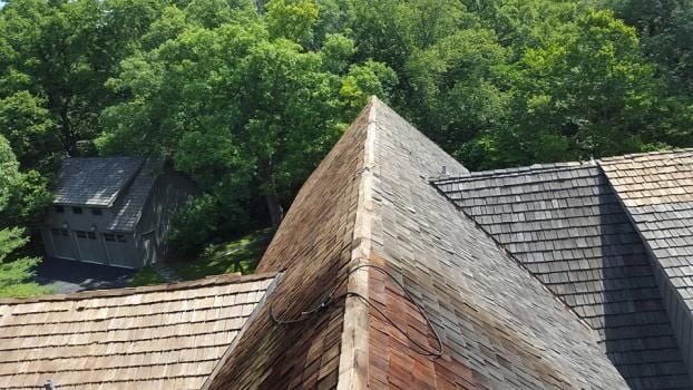 You can see the difference in this picture showing what a good power washing can do for your cedar roof.   